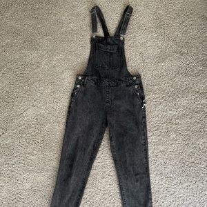 black overalls with music notes on the pockets